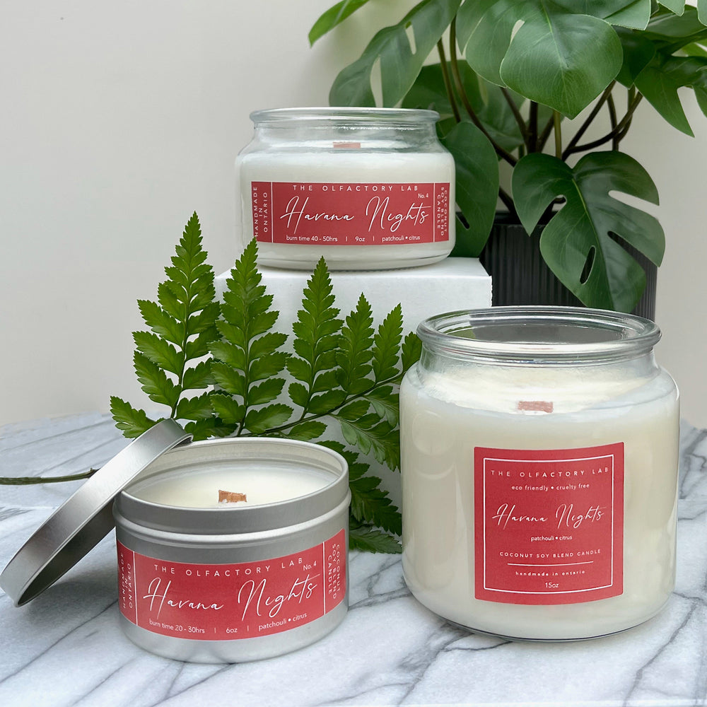 
                  
                    A trio of the 6oz, 9oz, and 15oz Havana Nights candles. Candles are sitting on a grey marble table with greenery in the background.  
                  
                
