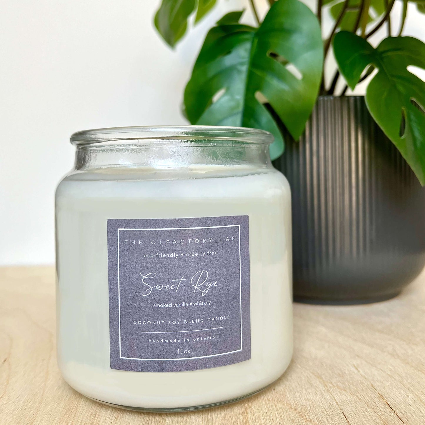 
                  
                    15oz white candle. Candle label is a square shape in a dark grey colour with white cursive font reading Sweet Rye. Candle is sitting on a wood table with greenery in the background.
                  
                