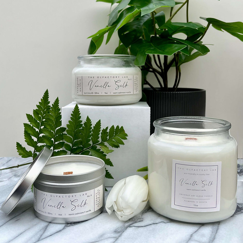 
                  
                    A trio of 15oz, 9oz, and 6oz Vanilla Silk candles. The candles are on a grey and white marble table with greenery in the background.
                  
                